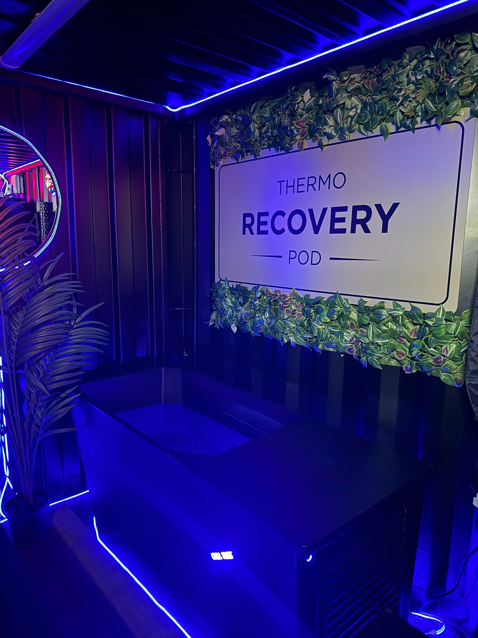 Thermo Recovery Pod blue neon interior with branded signage