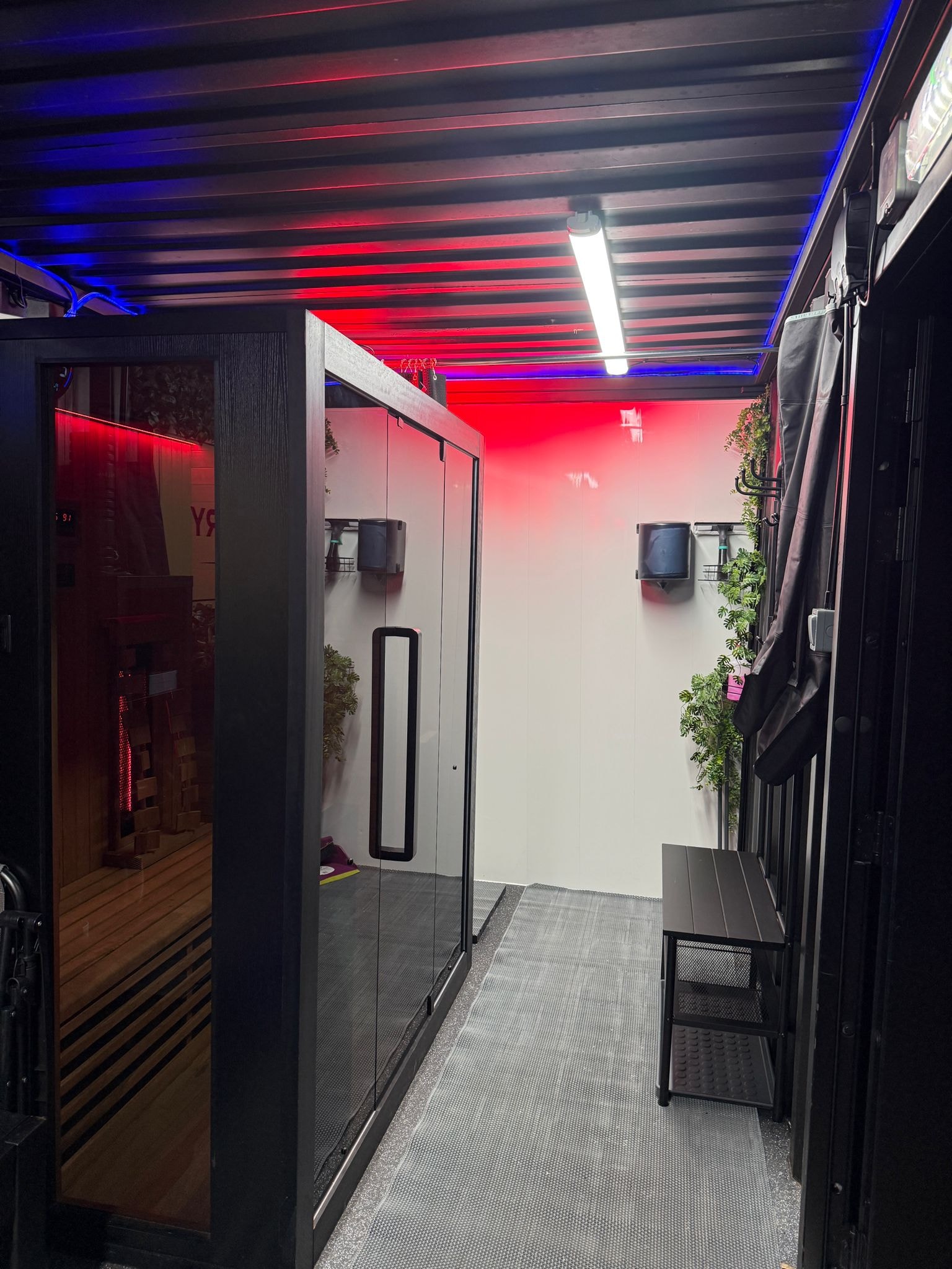 Thermo Recovery Pod interior corridor with red and blue neon ceiling lighting